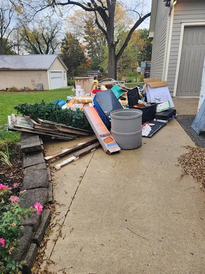 Dumpster being loaded with debris for Estate Cleanout Dumpster Rental in Brownstown